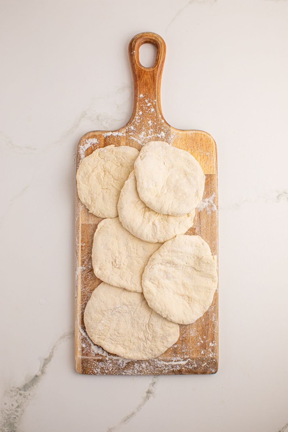 3 Ingredient Flatbread dough rolled out into circles on a cutting board 