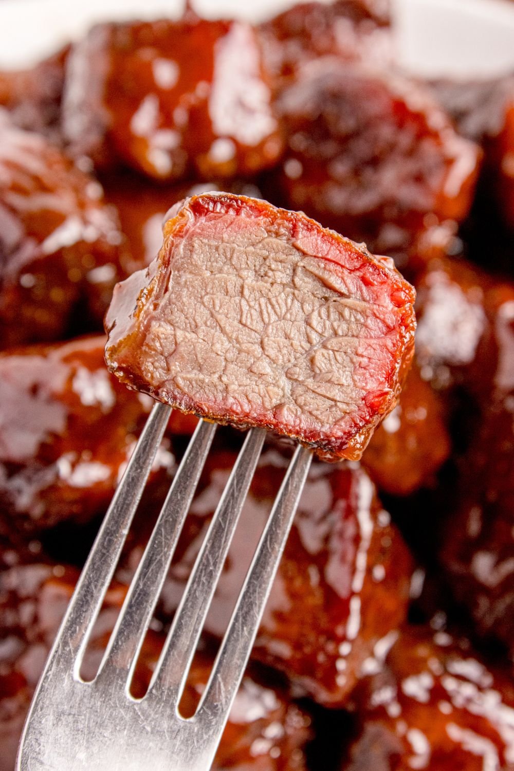 Chuck Roast Burnt End on a fork with a bite taken out of it 