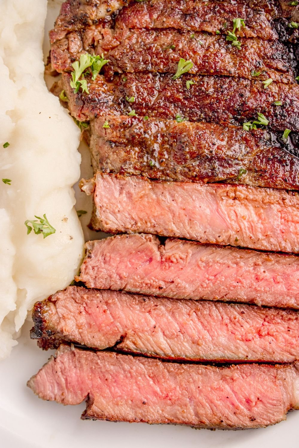 overhead look on plate with Grilled Ribeye Steak sliced on plate 
