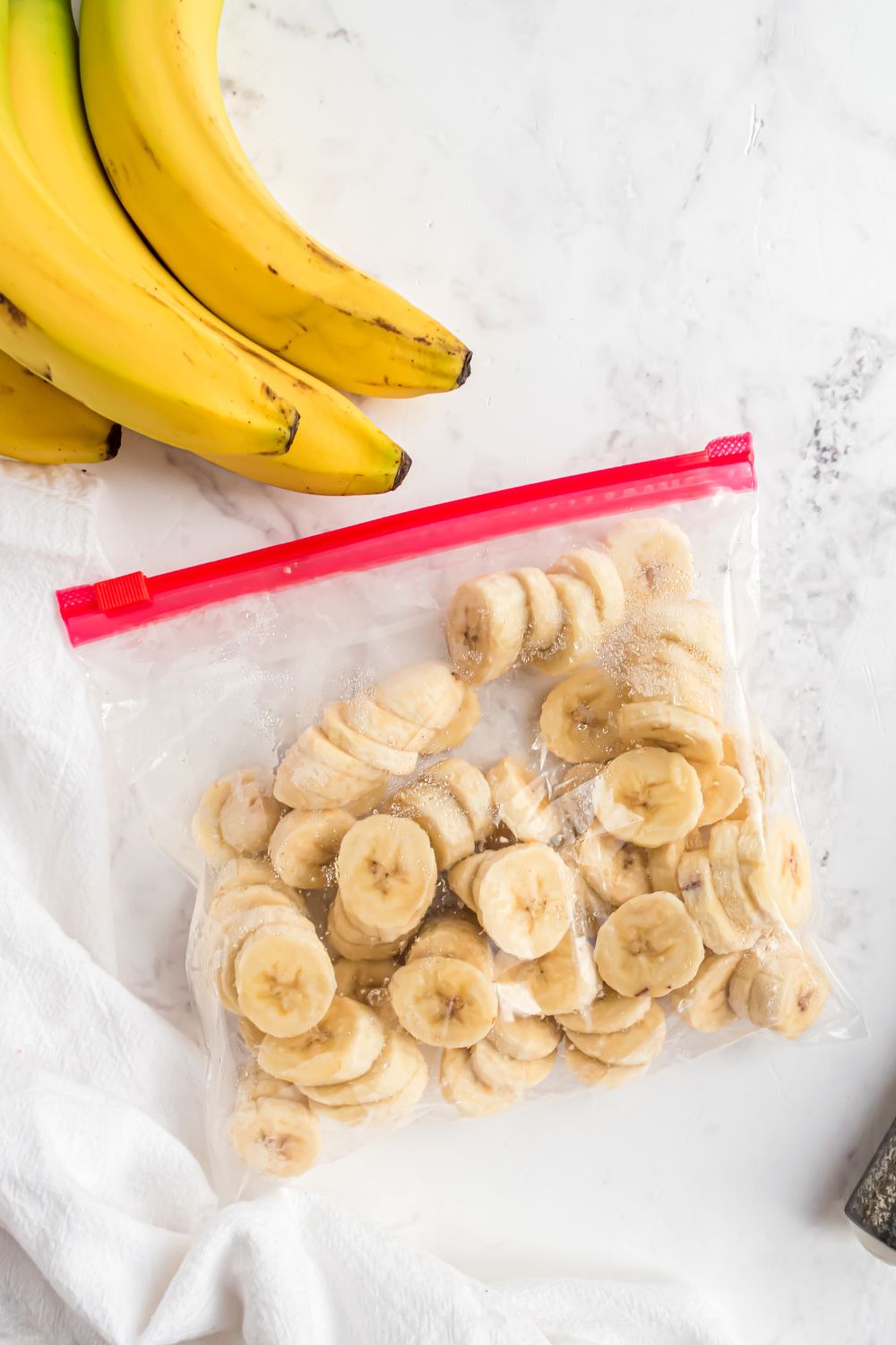 frozen bananas in a ziploc bag on table