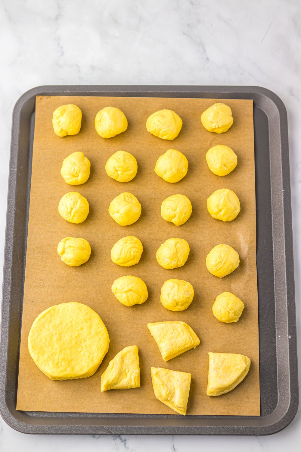 biscuit dough cut into pieces and rolled into balls