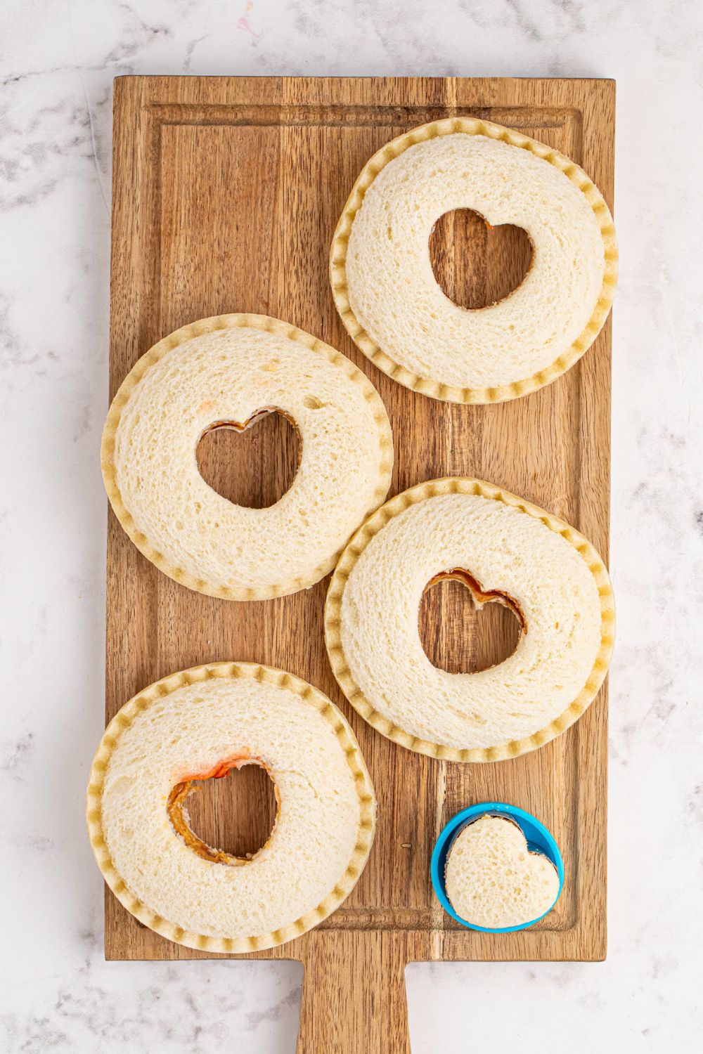 Homemade Strawberry Uncrustables with hearts cut out in center of each one with a cookie cutter 