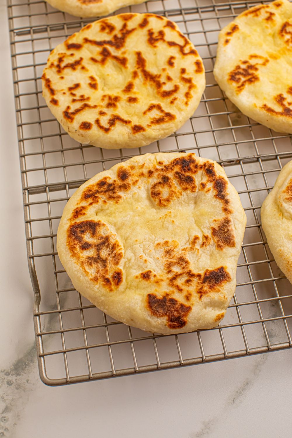 3 Ingredient Flatbreads on a cooling rack in a single layer 