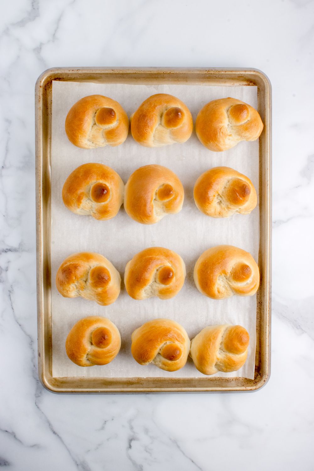 baked garlic knots on a tray on table