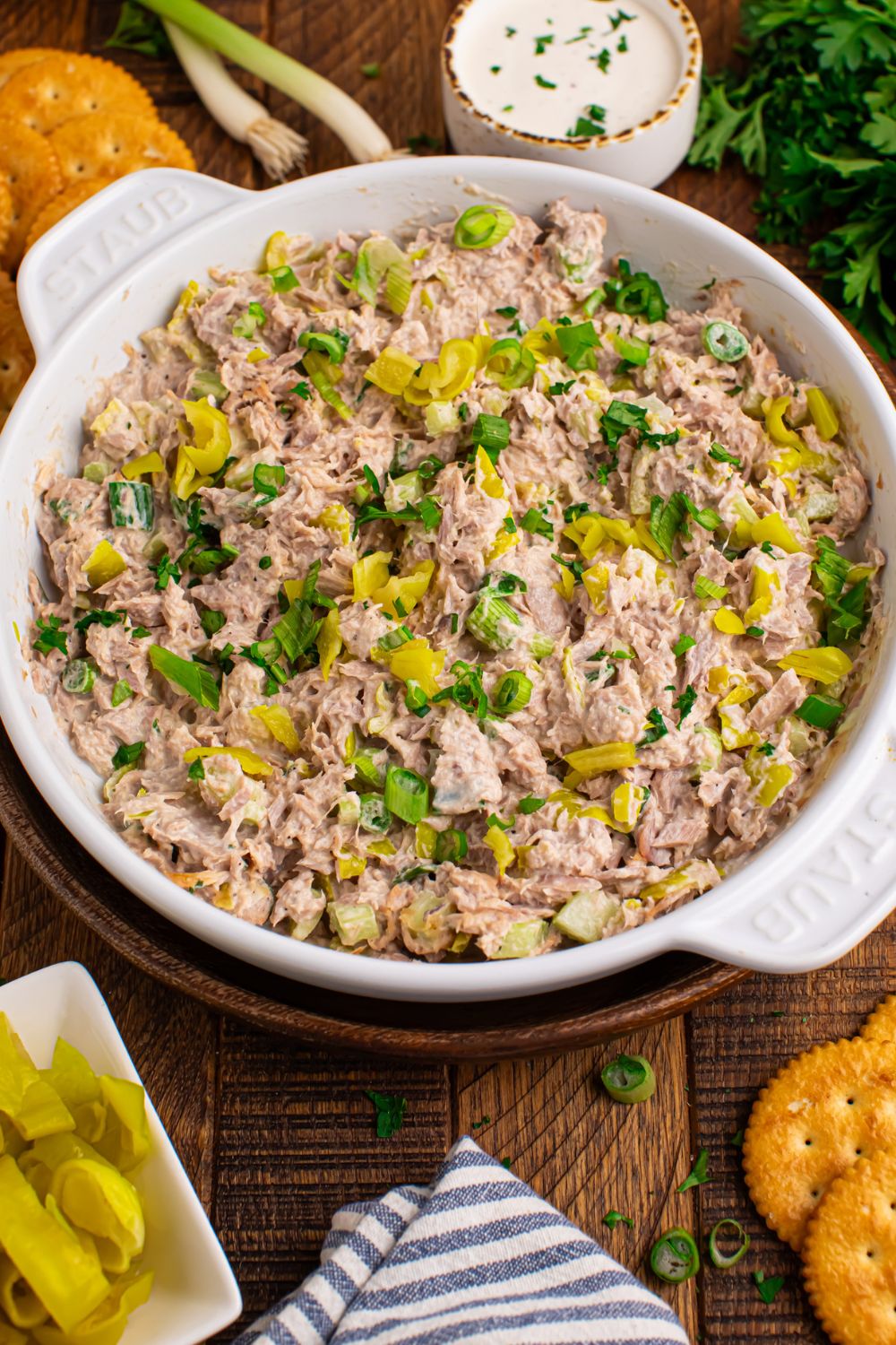 Pepperoncini Ranch Tuna Salad on table in a white bowl with some crackers to side for dipping 