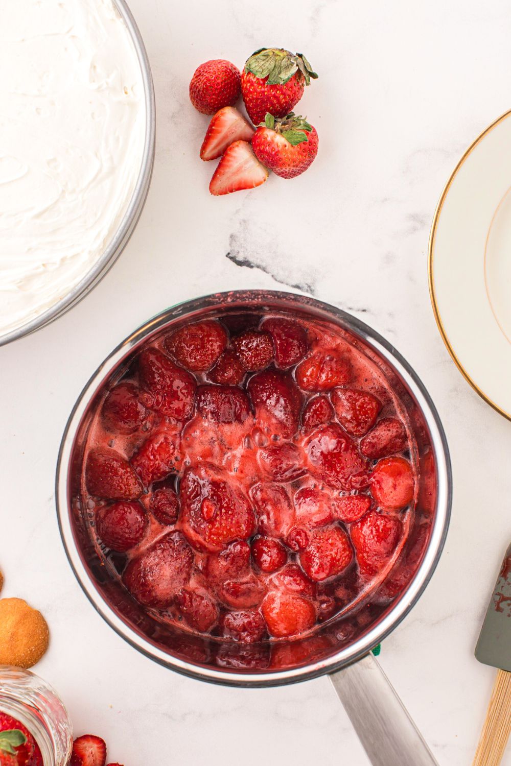 strawberries cooked into a glaze for topping the no bake cheesecake 