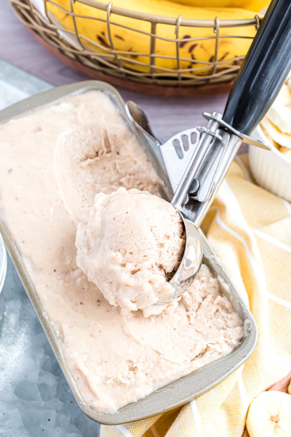 loaf pan with Banana Ice Cream in it and a scoop full of ice cream 