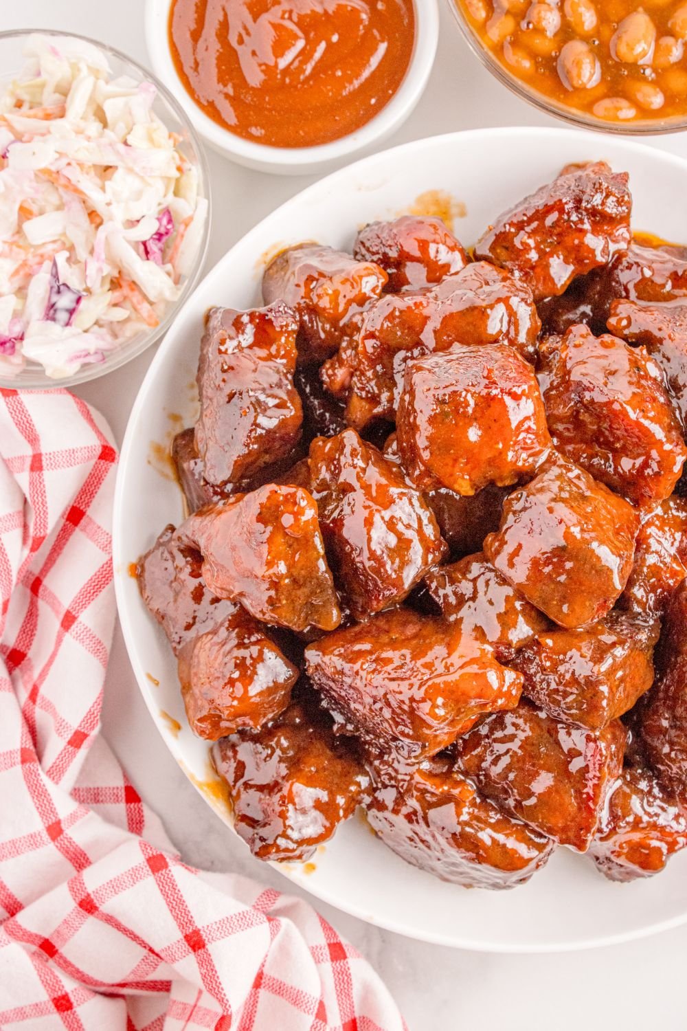 Chuck Roast Burnt Ends on a plate on table with a towel to the side 