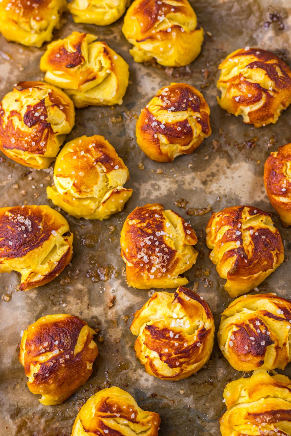 pretzel bites on cooking tray on table sprinkled with salts 