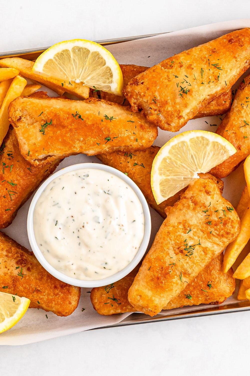 Easy Homemade Tarter Sauce in a bowl with fish to side