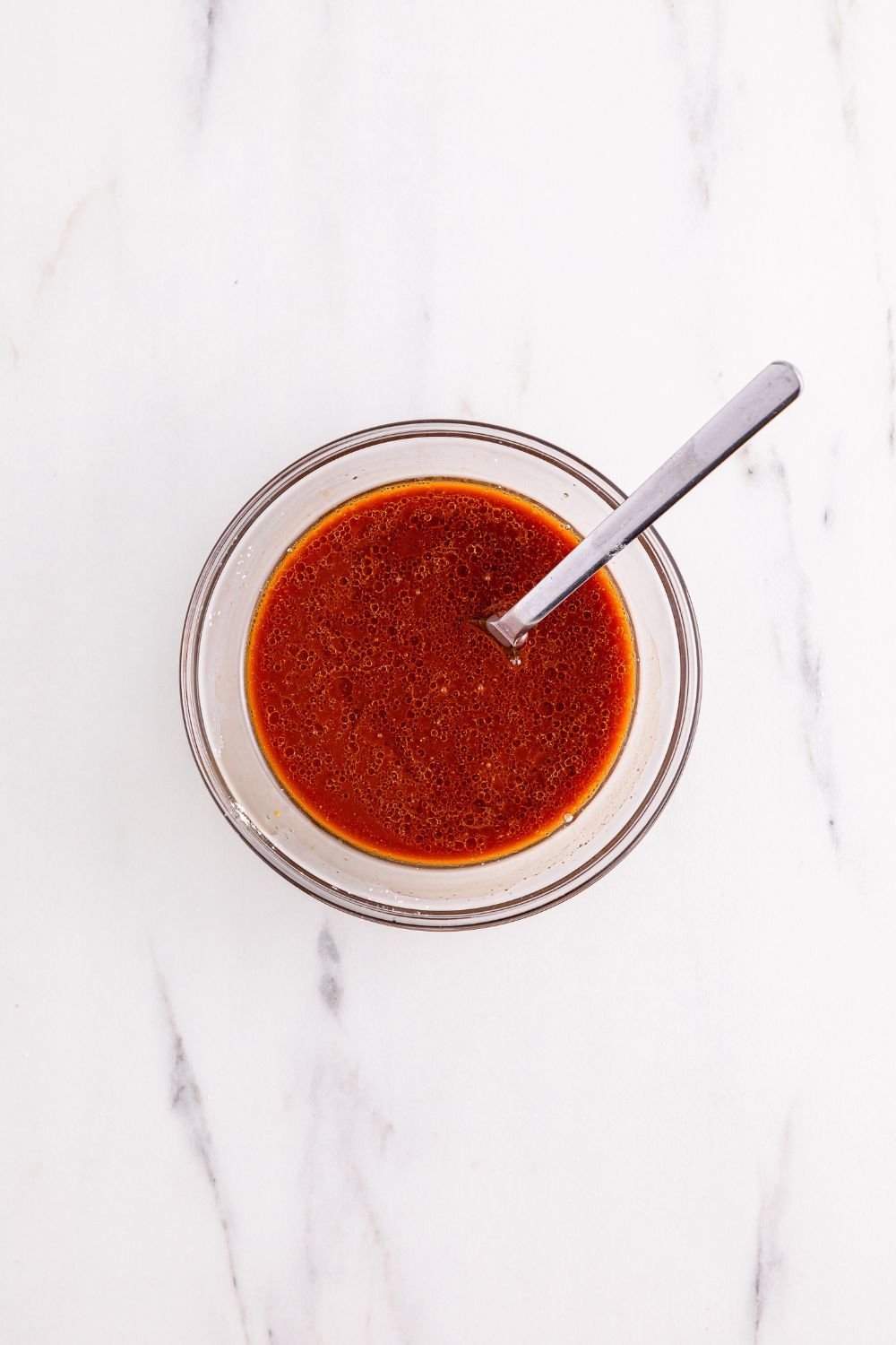 stirred Better Than Takeout Kung Pao Chicken sauce in a bowl with a spoon in it