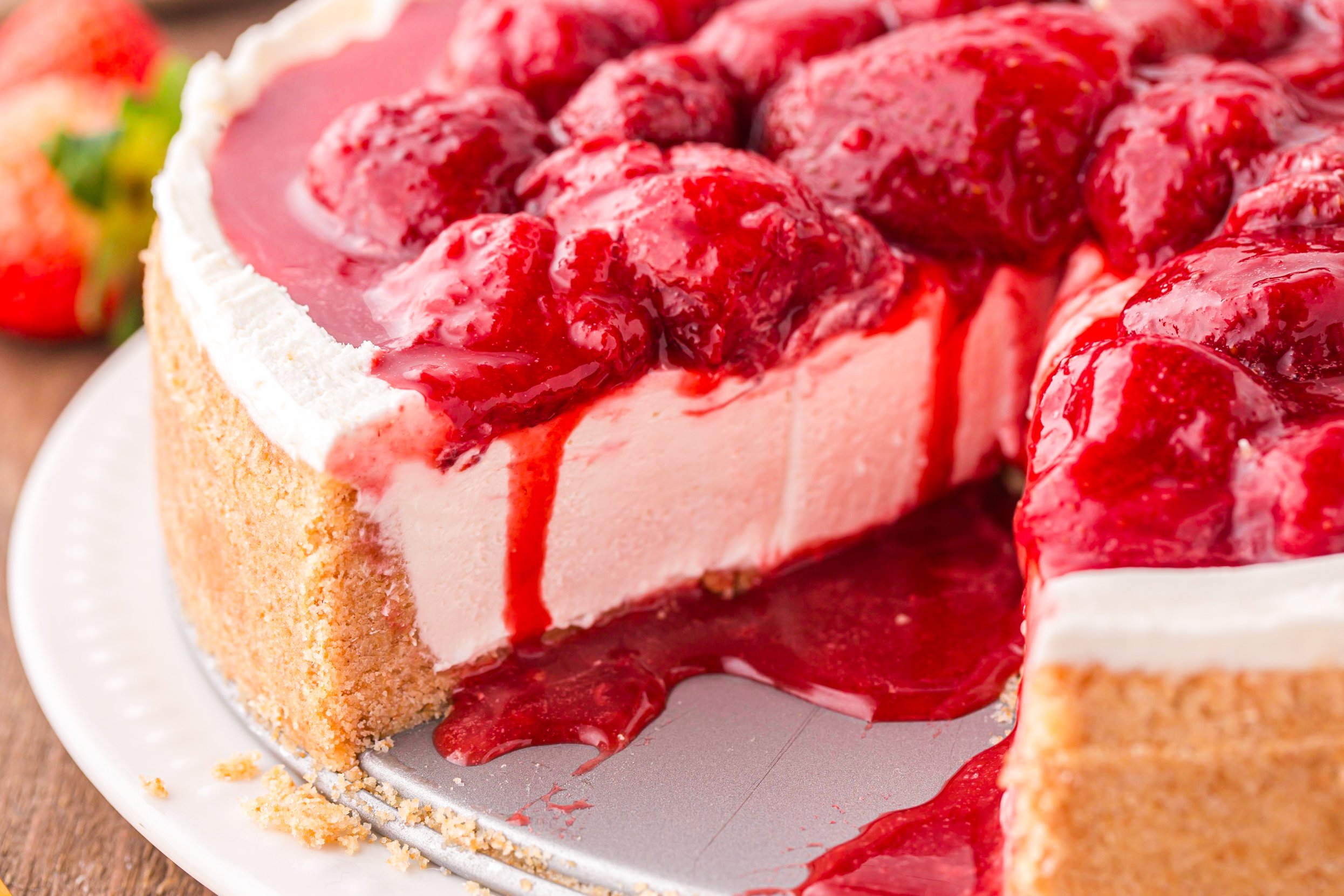 No Bake Strawberry Cheesecake with a slice missing showing the inside