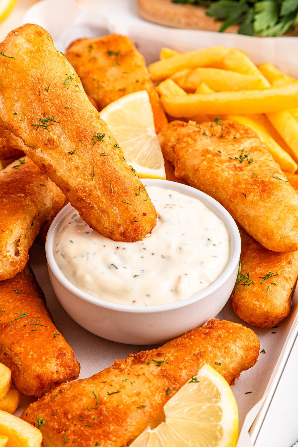Easy Homemade Tarter Sauce in a bowl with a fish fillet dipping in bowl 