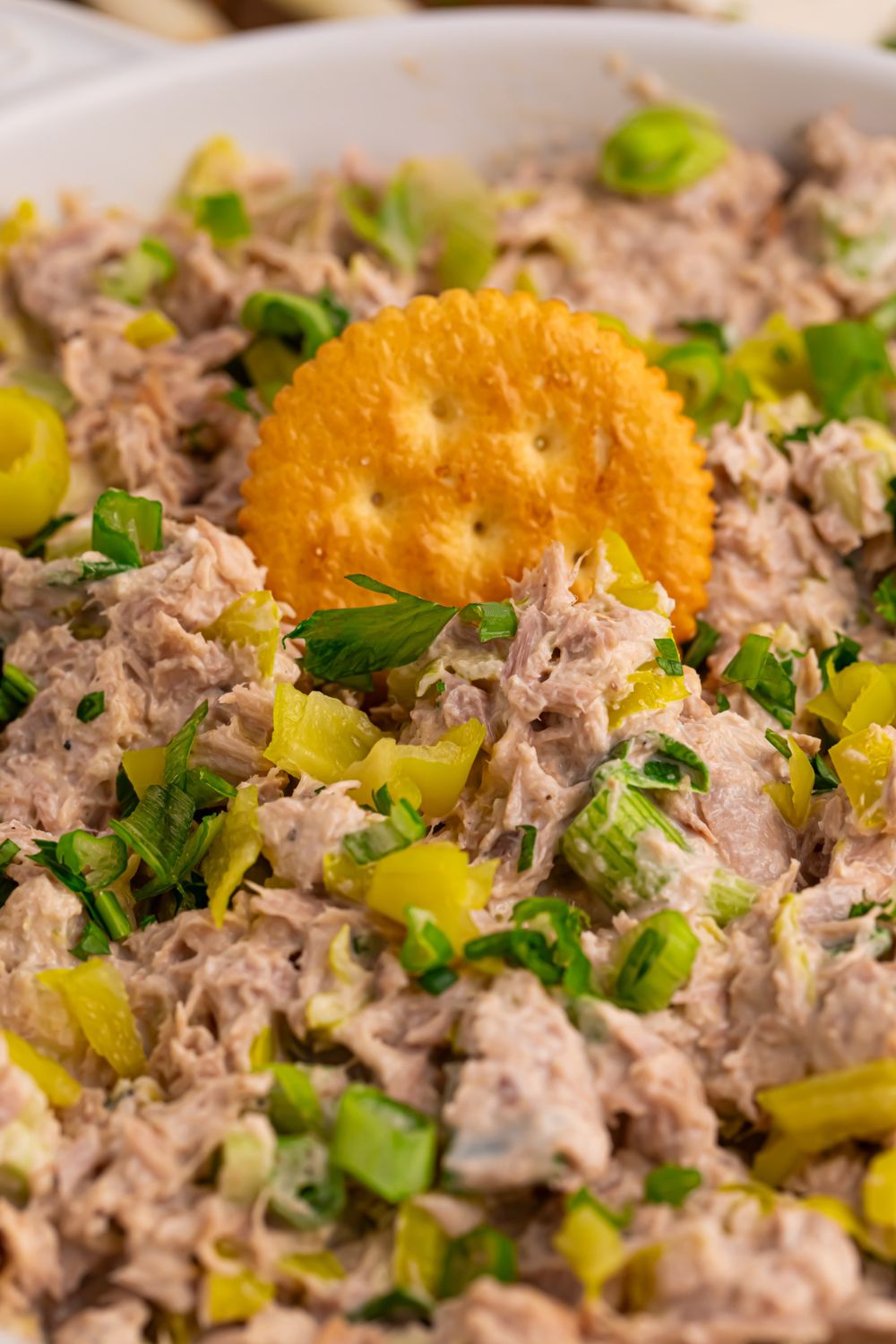 bowl of Pepperoncini Ranch Tuna Salad with a cracker pressed into it 