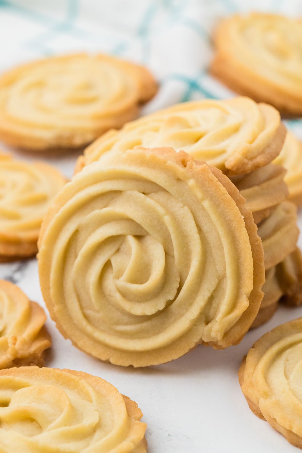 Butter Cookies stacked in piles on table 