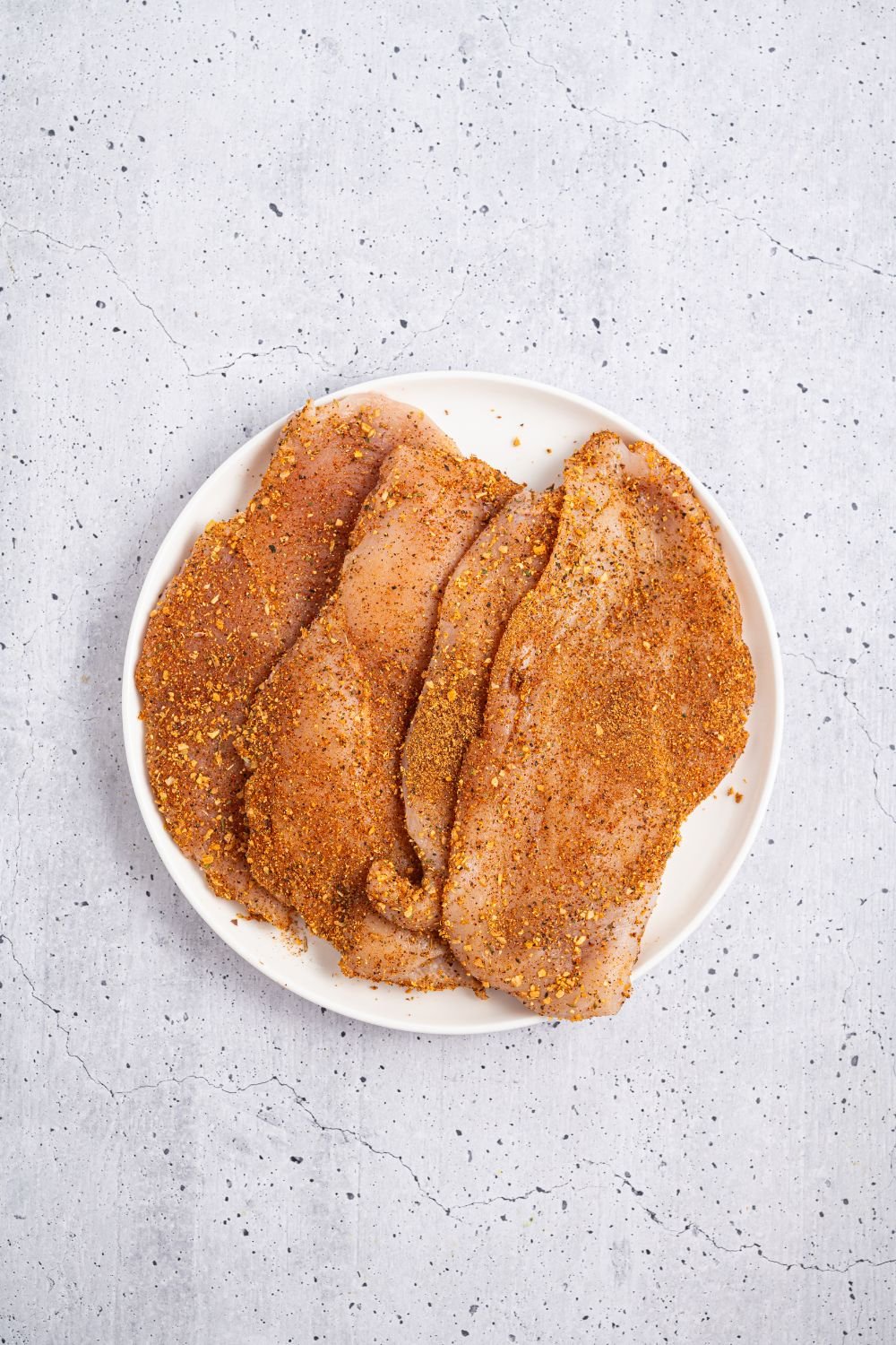 seasoned raw chicken on a plate