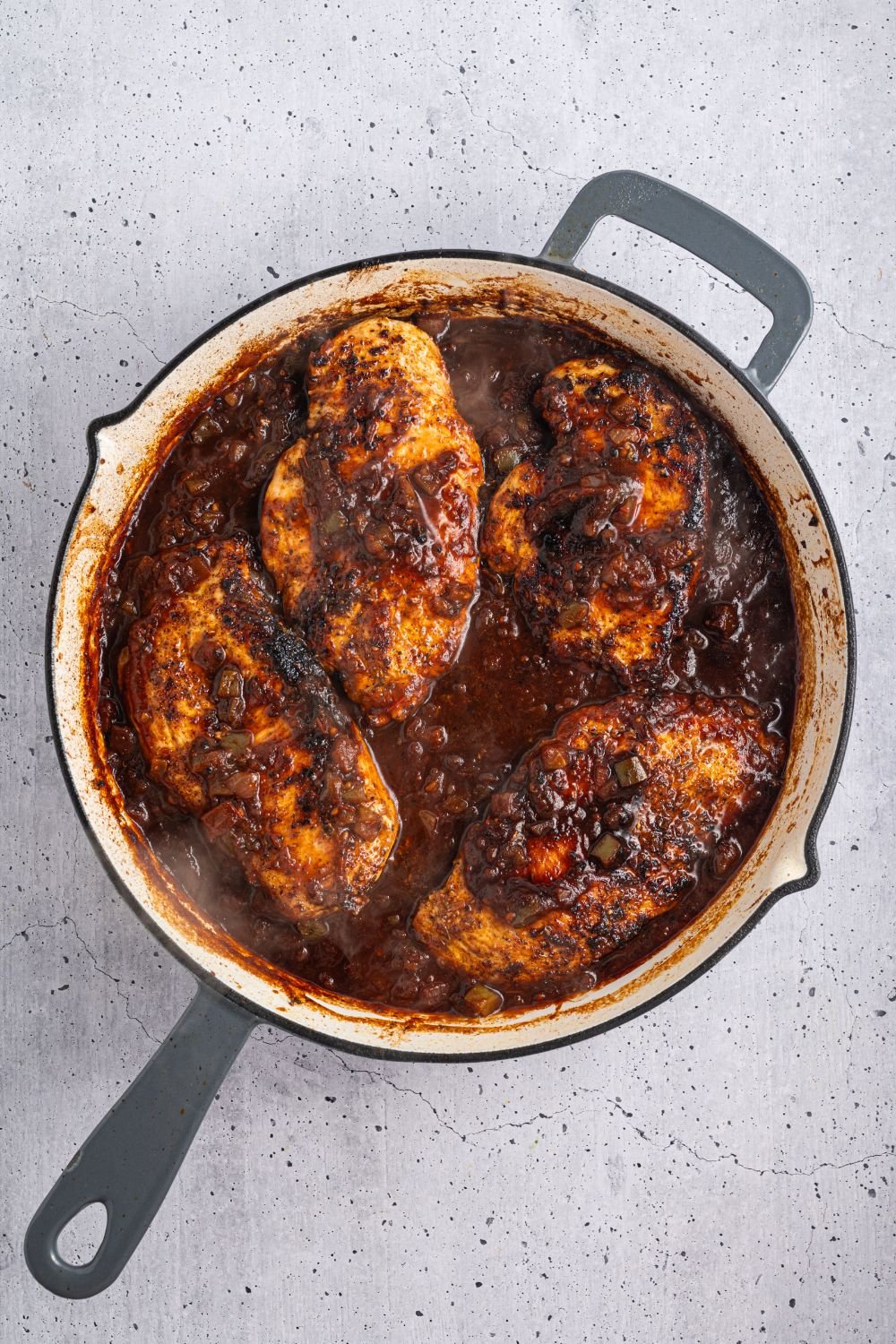 Cheesy Salsa Chicken in a skillet on table 