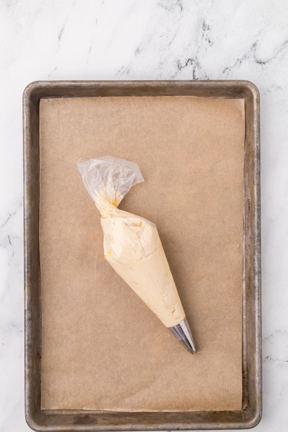 Butter Cookies in a piping bag on table on cookie sheet