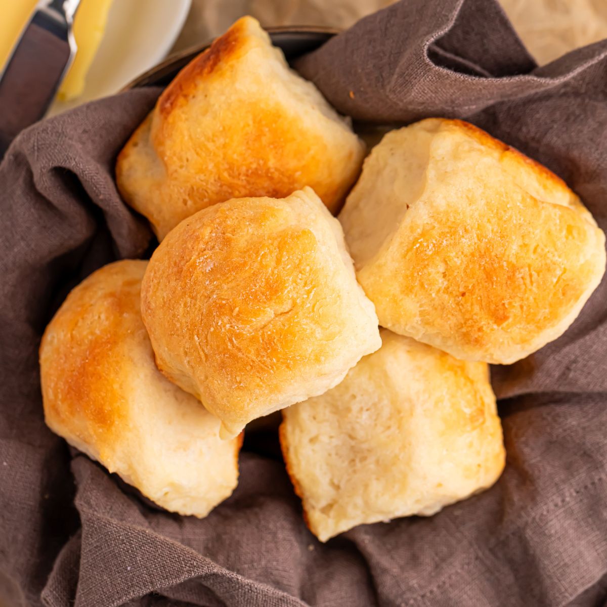 2 Ingredient Dinner Rolls in a basket with a towel inside of it