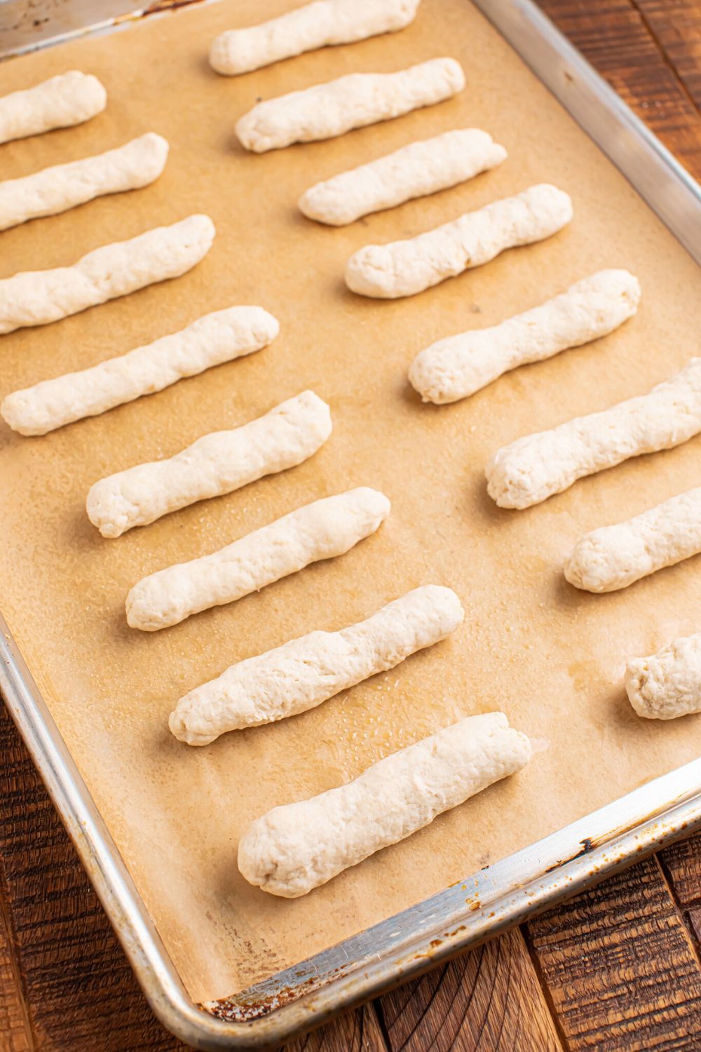 tray with 2 Ingredient Garlic Parmesan Breadsticks dough on a baking tray on table 