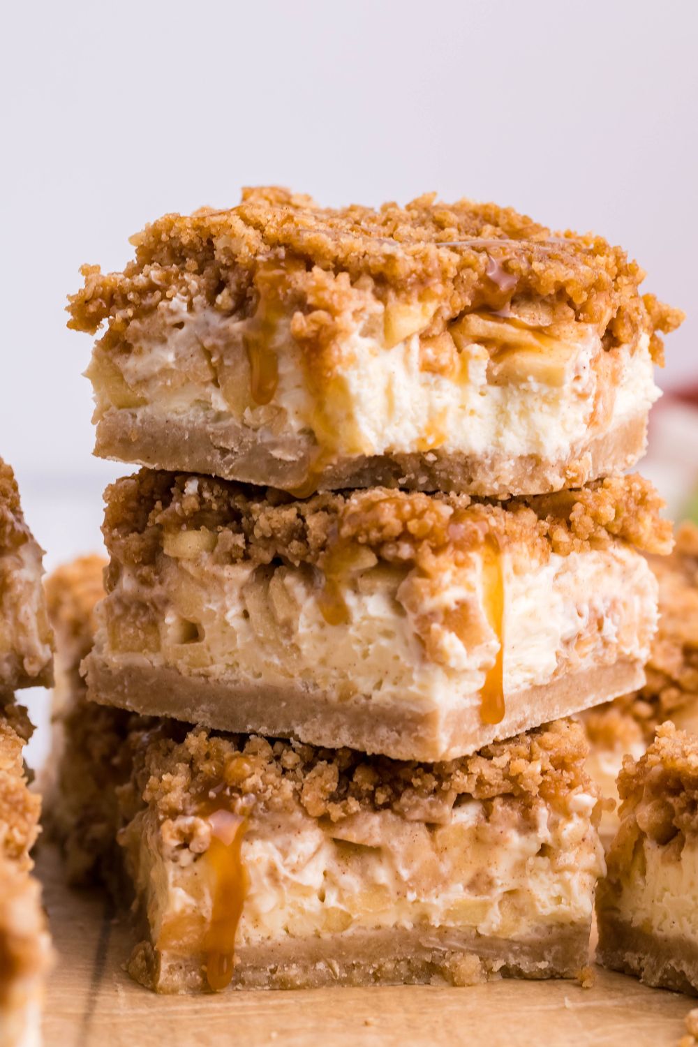 Caramel Apple Cheesecake Bars stacked on top of one another 