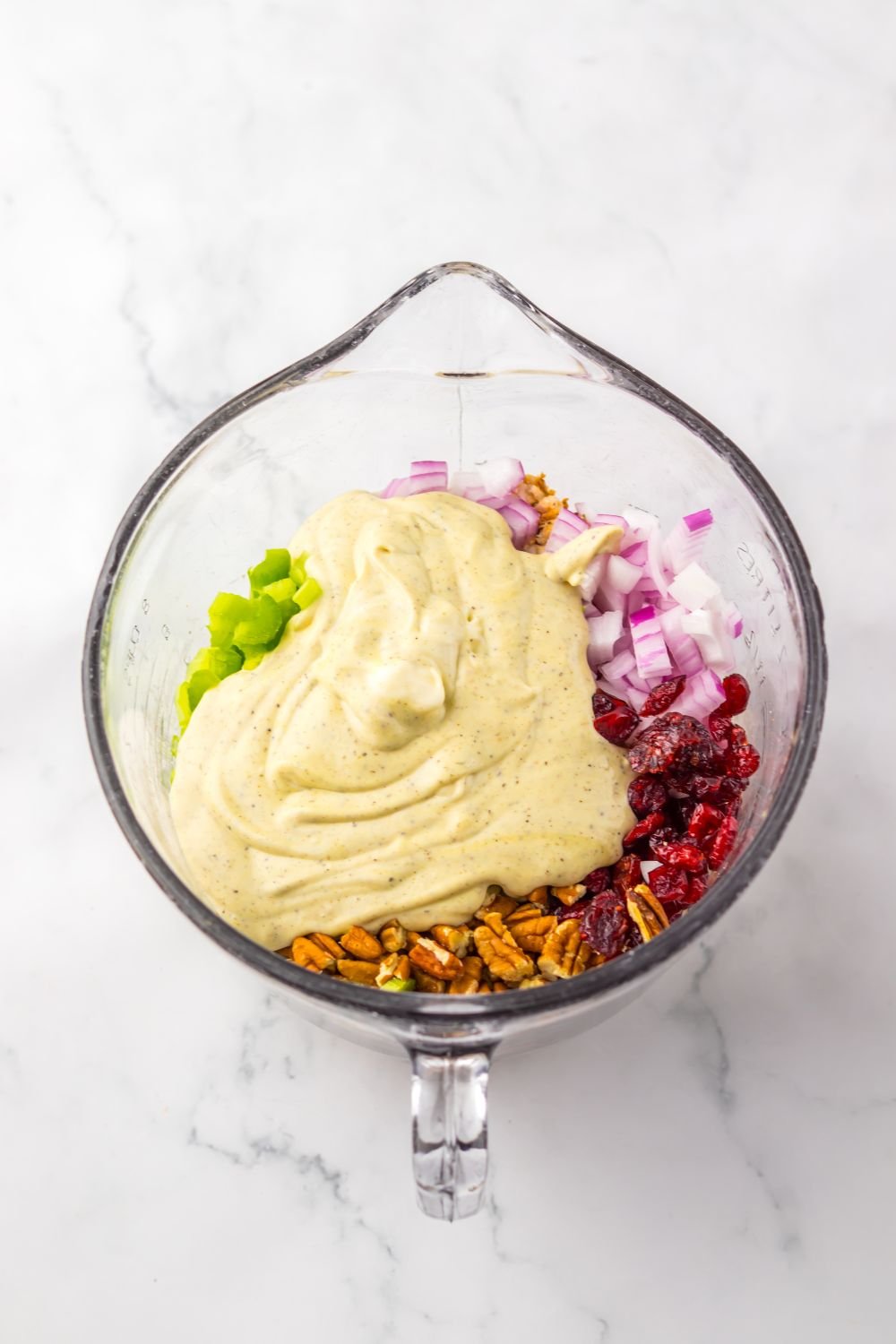 Thanksgiving Turkey Salad mixture in a measuring cup being mixed up