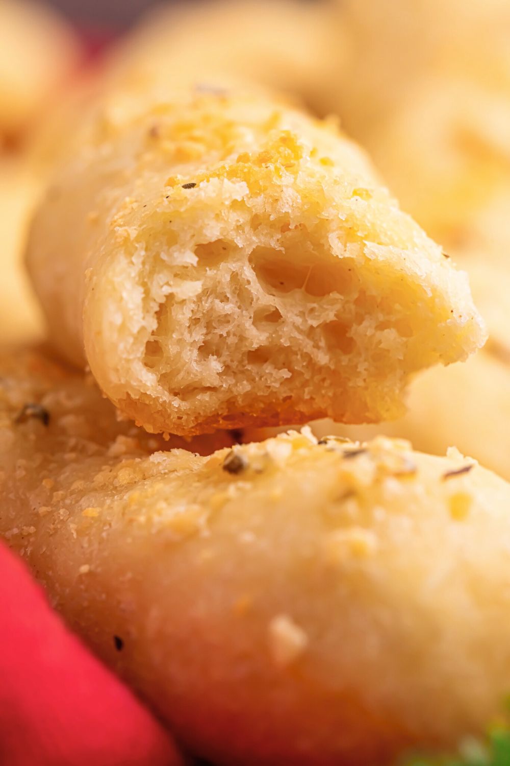 2 Ingredient Garlic Parmesan Breadstick on table with a bite taken out of it 