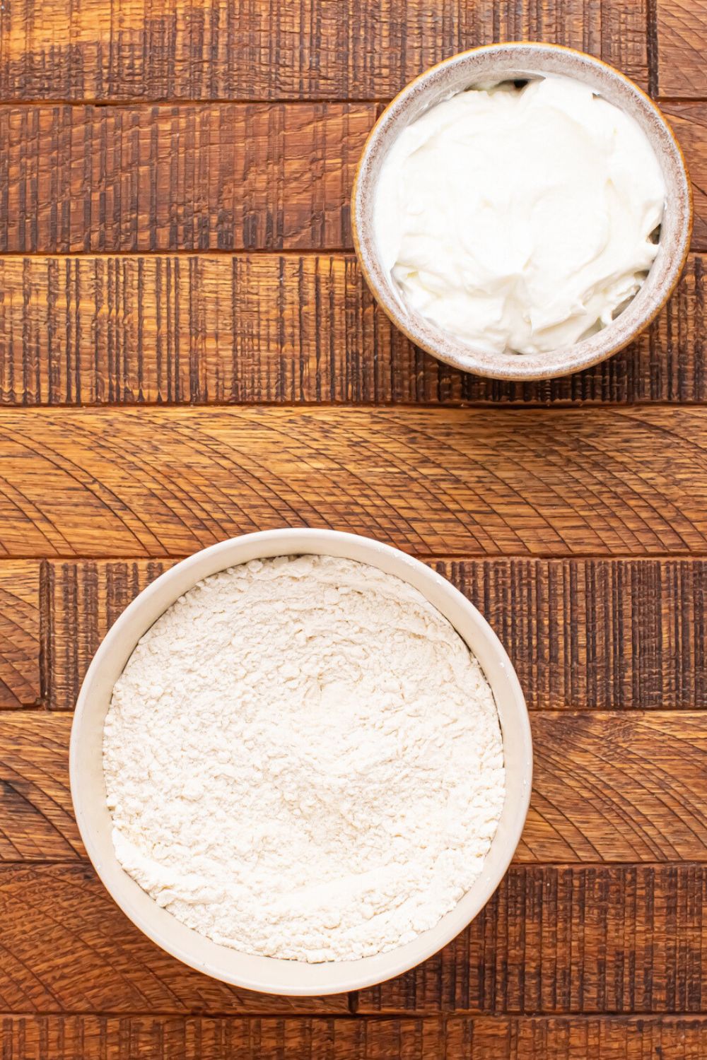 ingredients for making 2 Ingredient Garlic Parmesan Breadsticks  on table in single serve bowls 
