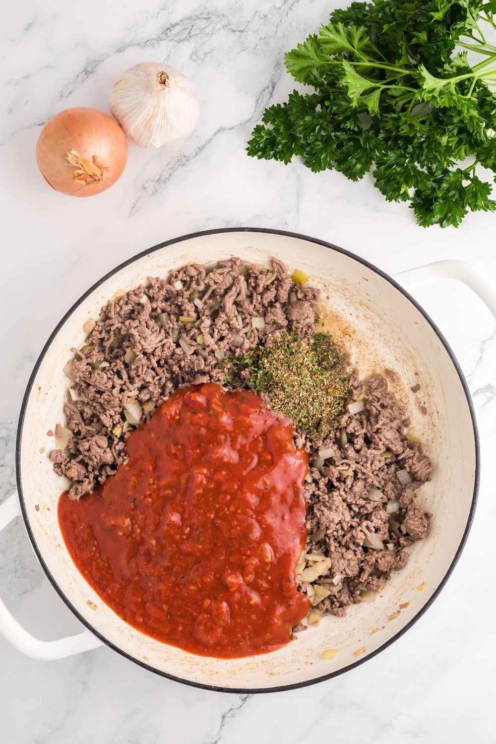 ground beef with sauce and spice in the pot for Million Dollar Spaghetti Casserole