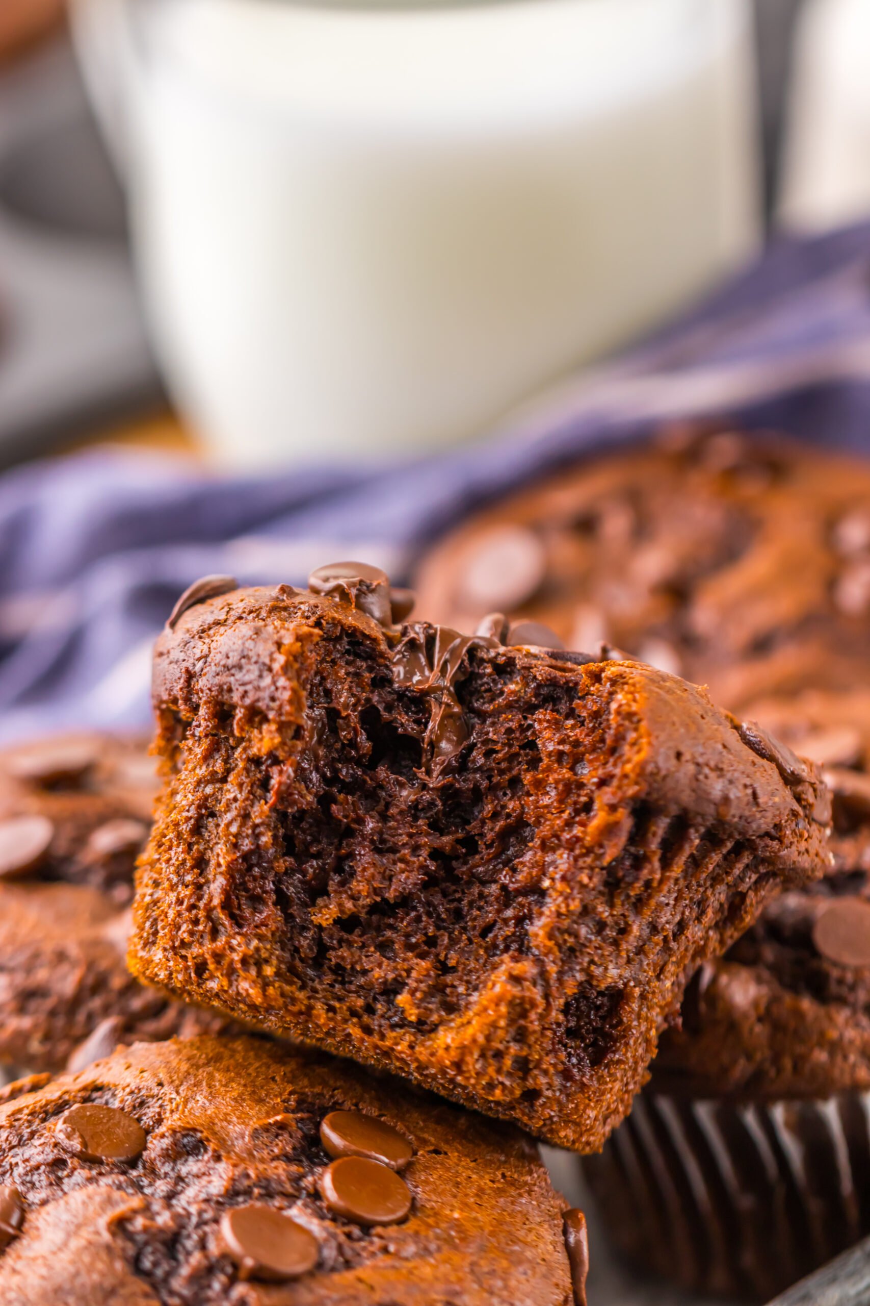 Costco Double Chocolate Muffins on with one on top with a bite missing