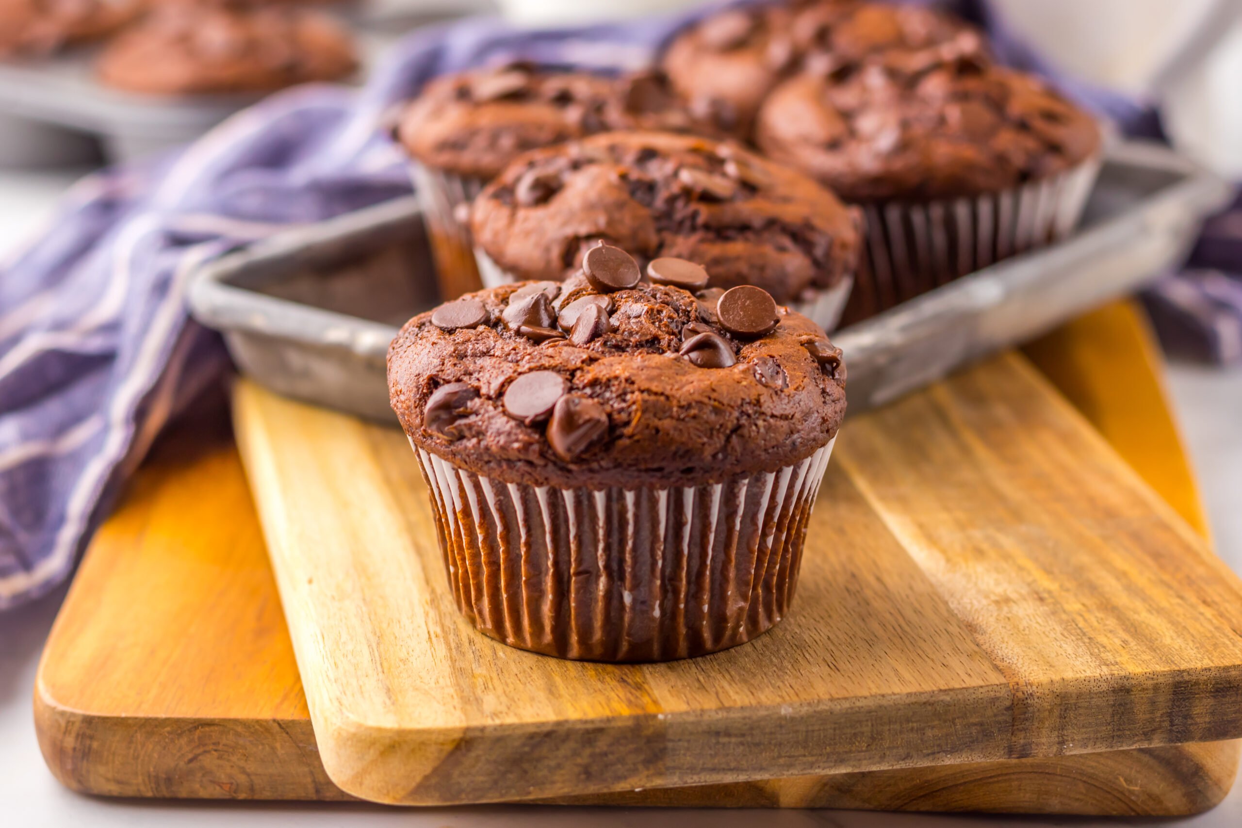 Costco Double Chocolate Muffins on a wooden cutting board up close 