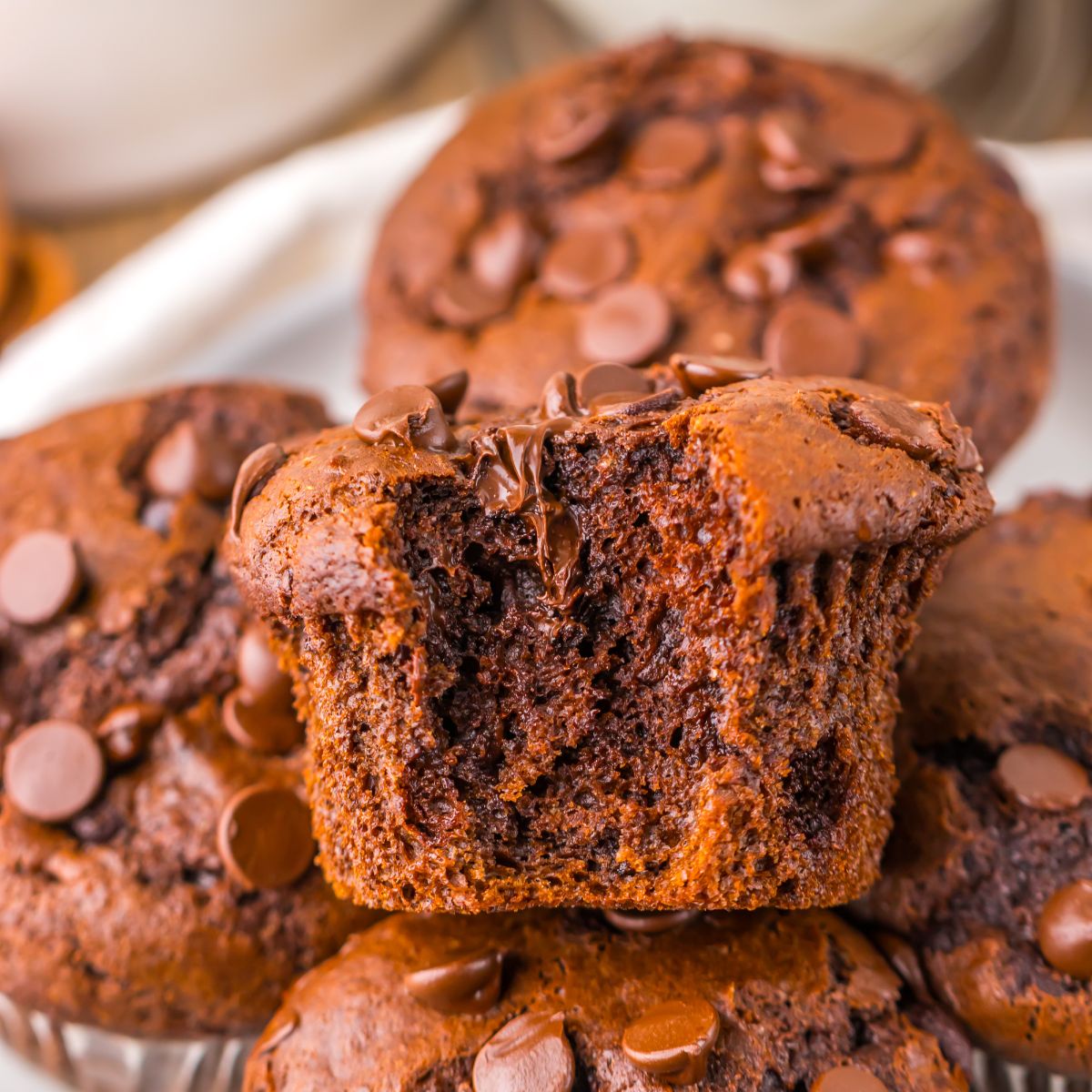 Costco Double Chocolate Muffins on plate with a bite taken out of one of the muffins 