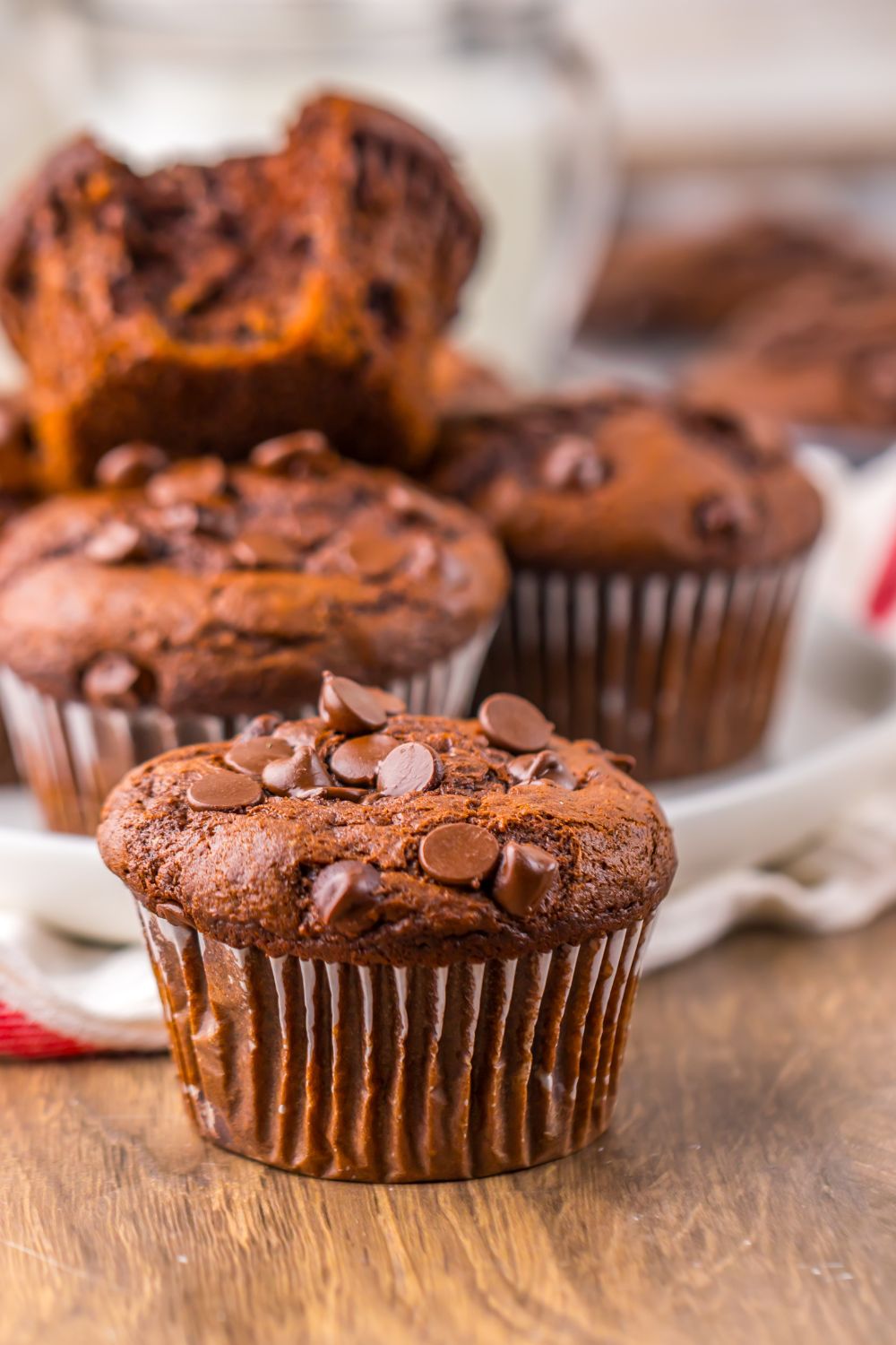 Costco Double Chocolate Muffins placed randomly on a table with a towel around muffins 