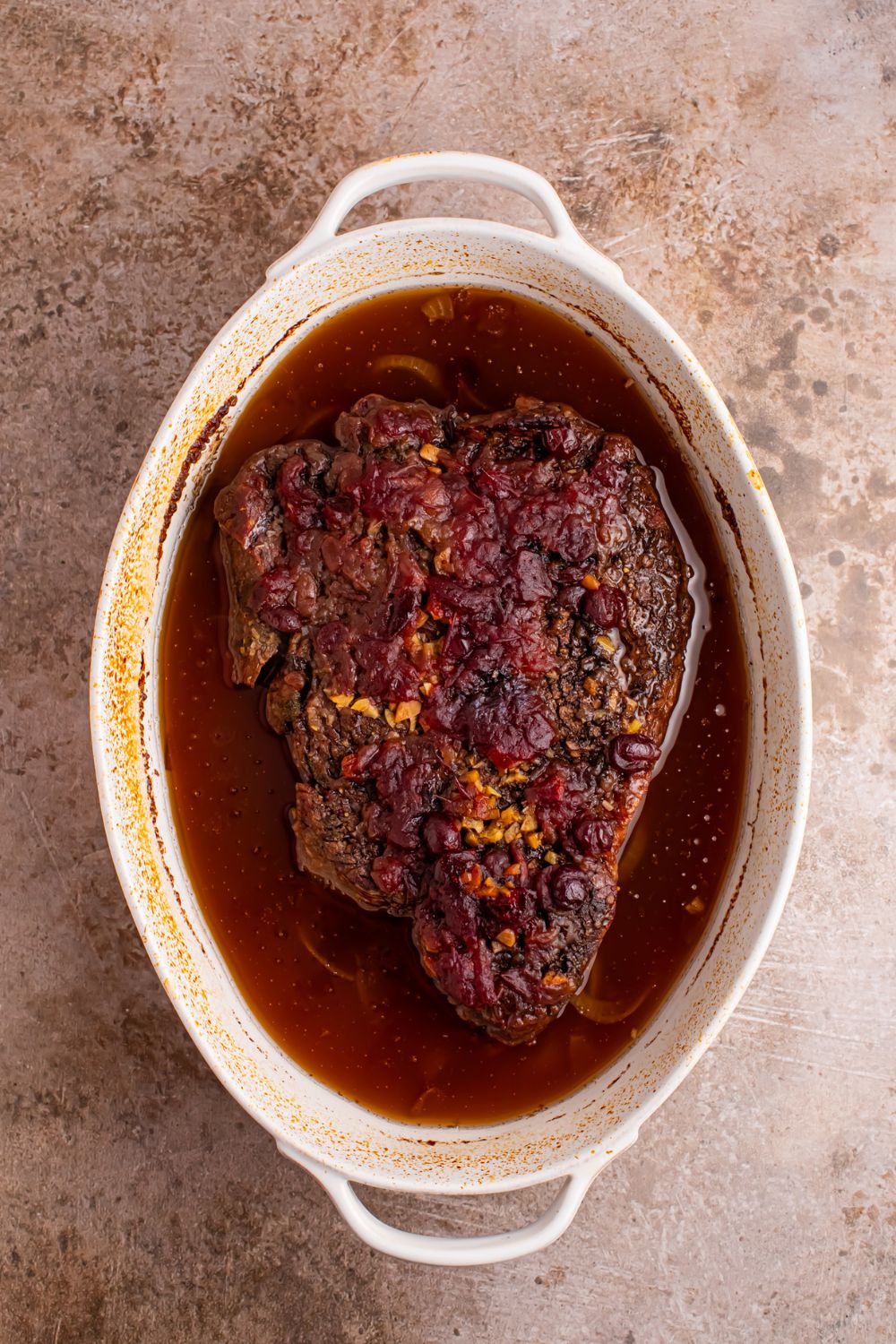 baked Cranberry Pot Roast in a casserole dish on table 