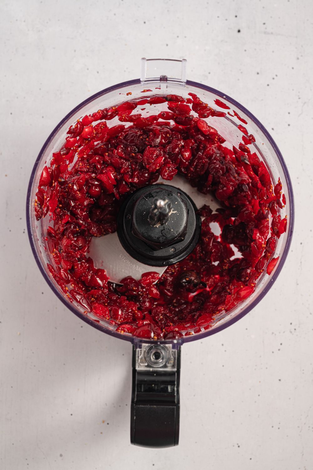 pureed Cranberries in a food processor on counter
