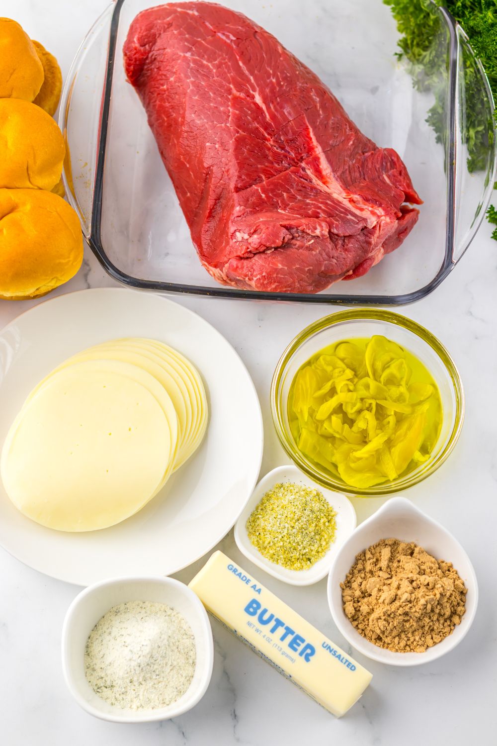 Slow Cooker Mississippi Pot Roast Sliders ingredients all on single serve containers sitting on table 