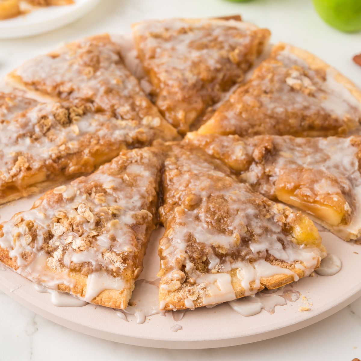 close up view of Easy Apple Pie Pizza cut and placed in a circle and on table 