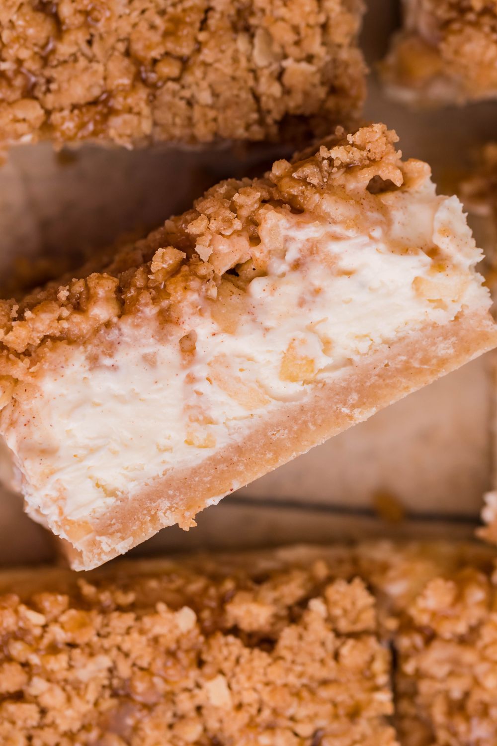 Caramel Apple Cheesecake Bar on its side on table with more placed around it on table 
