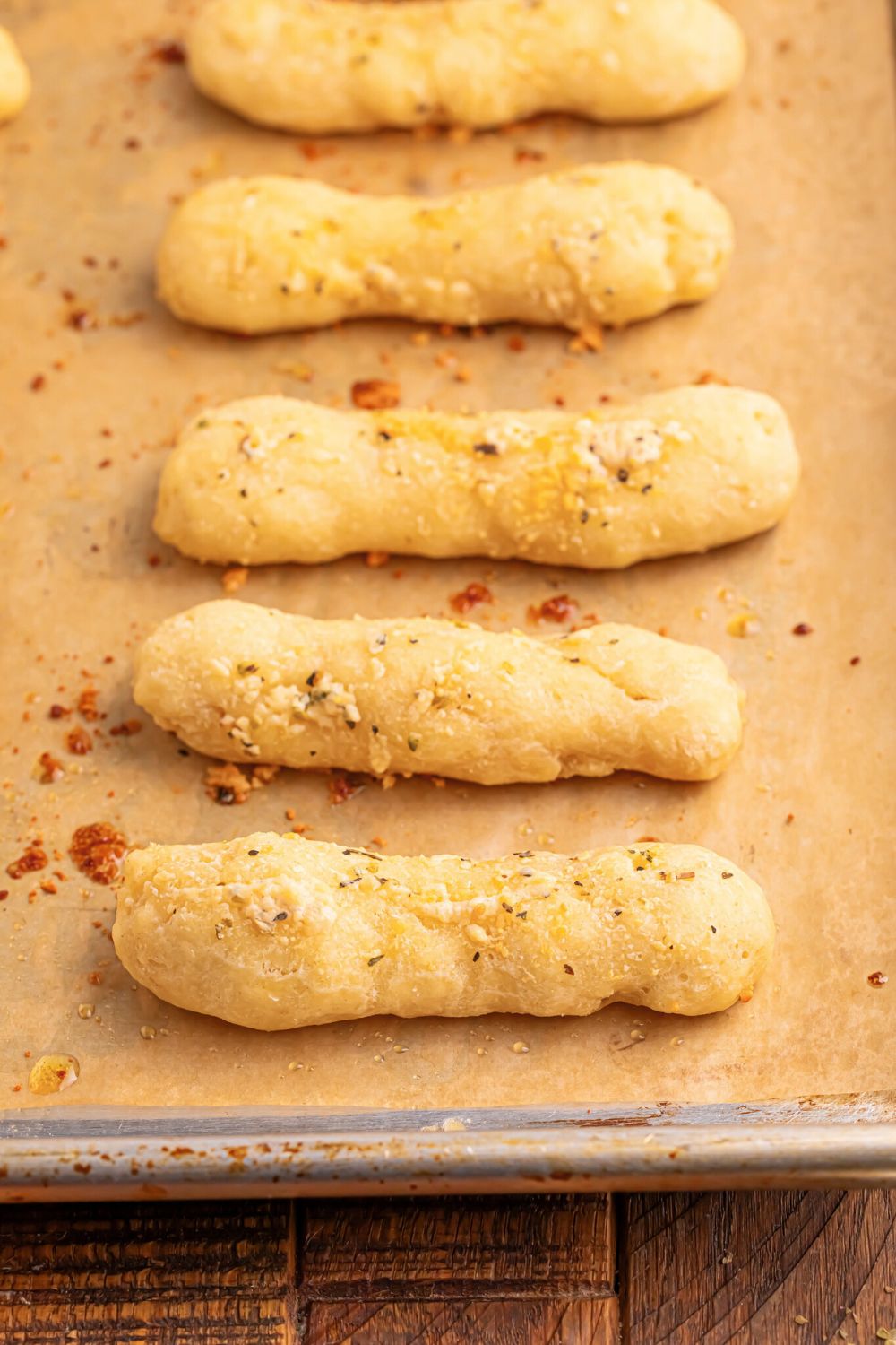 line of 2 Ingredient Garlic Parmesan Breadsticks on a baking tray 