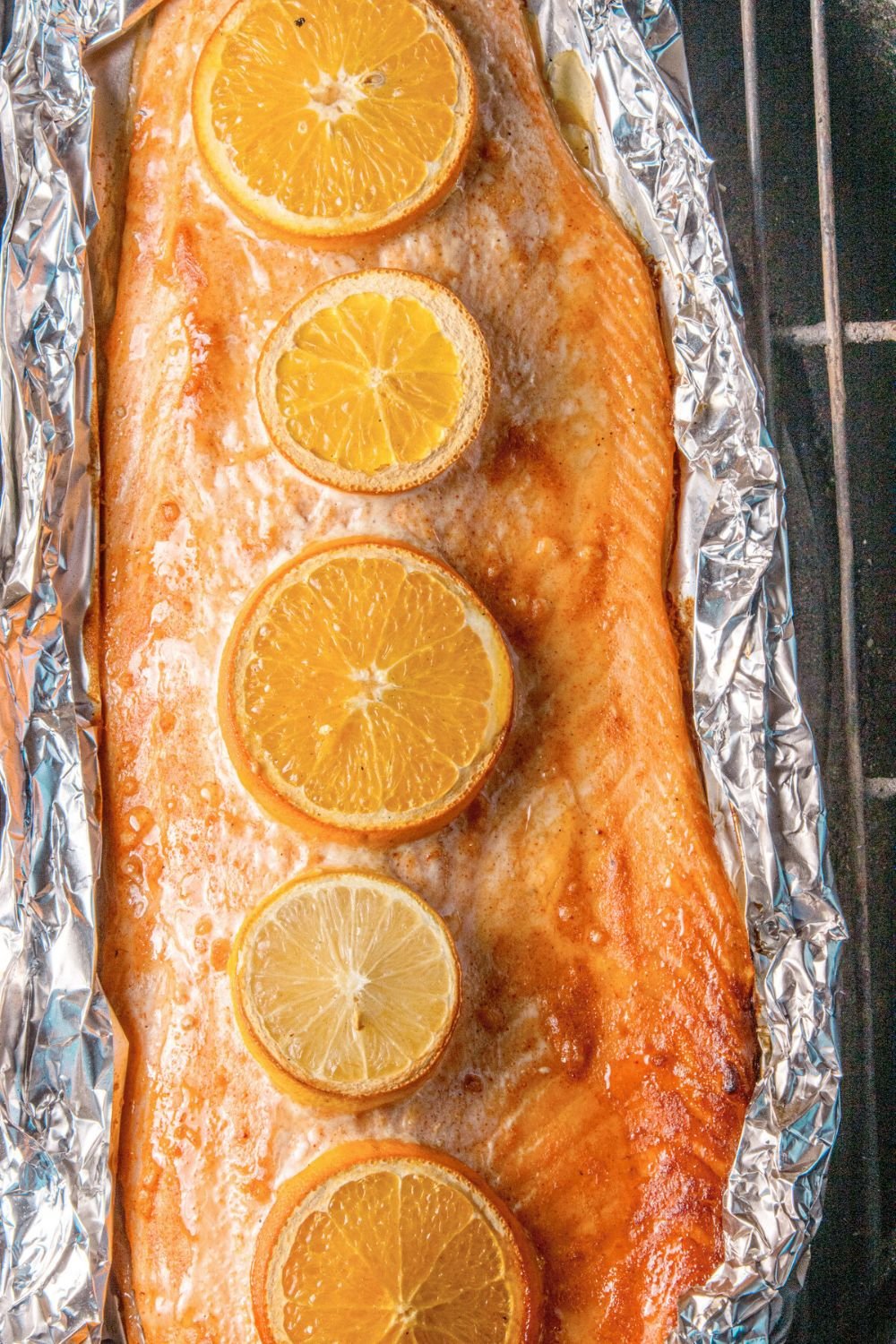 Grilled Honey Mustard Salmon in Foil sitting on a charcoal grill 