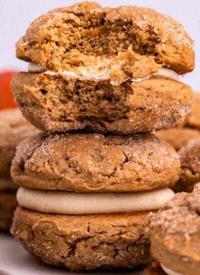 Apple Cider Whoopie Pies stacked with a bite missing from the top one