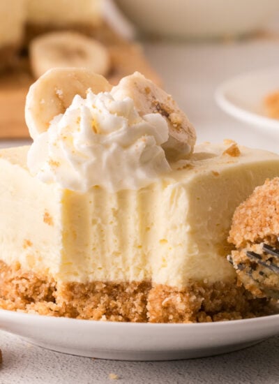 No Bake Banana Pudding Cheesecake Bar on a white plate with a bite missing