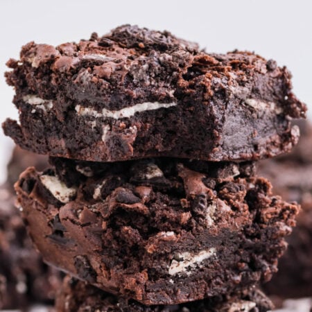 Oreo Stuffed Brownies stacked on top of one another on table