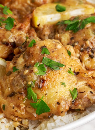 Instant Pot Lemon Butter Chicken in a bowl with rice under it on table
