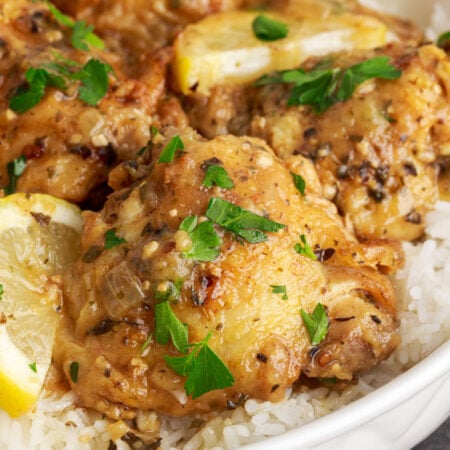 Instant Pot Lemon Butter Chicken in a bowl with rice under it on table