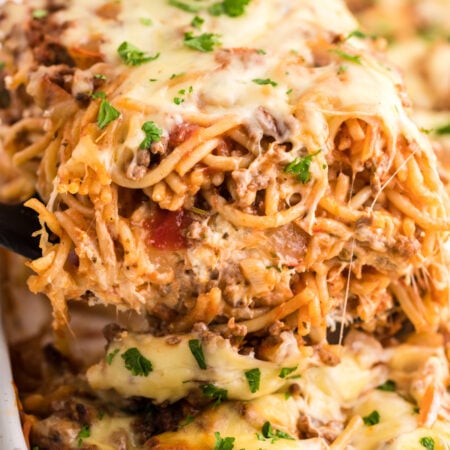 Million Dollar Spaghetti Casserole slice being lifted up with a spatula