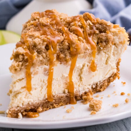 Caramel Apple Crisp Cheesecake slice on a white plate