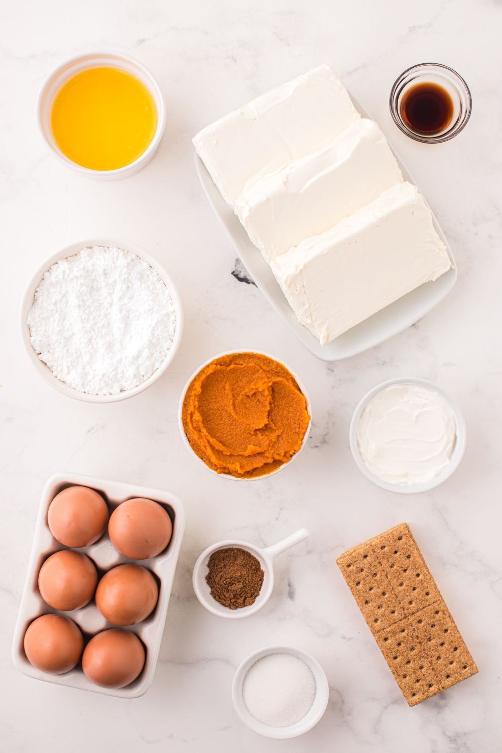 Swirled Pumpkin Cheesecake Bar ingredients on table in their own containers