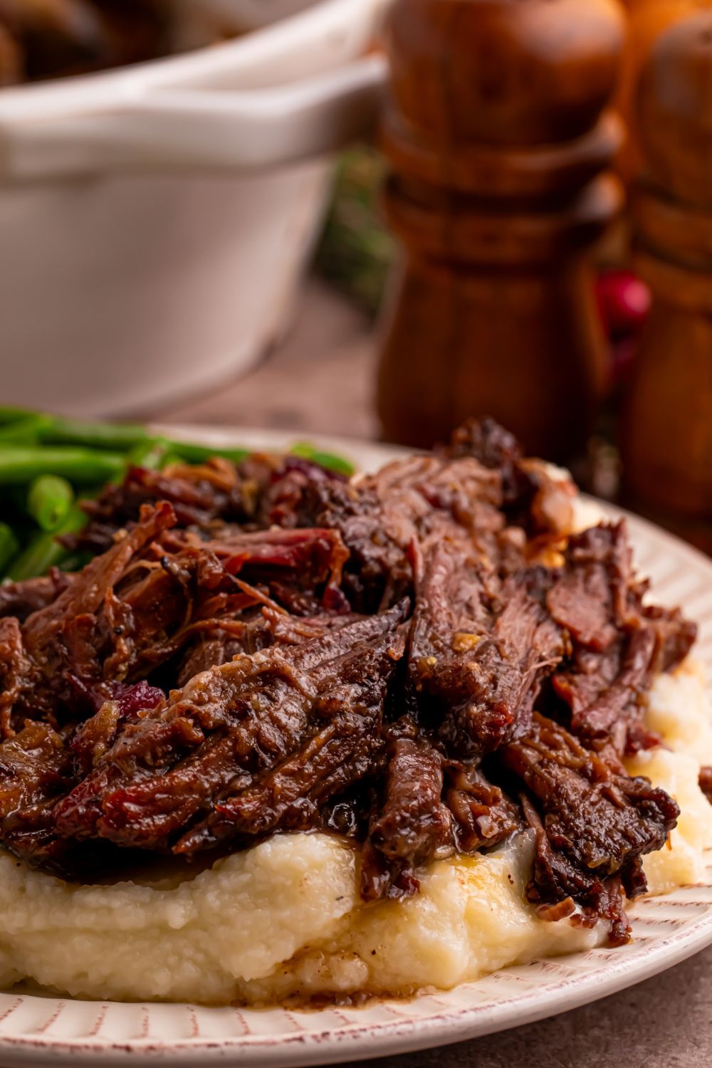 Cranberry Pot Roast on plate with mashed potatoes under it 