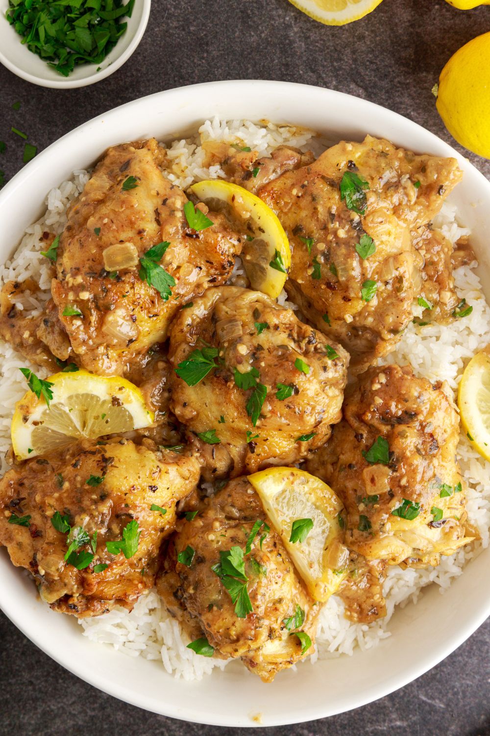 Instant Pot Lemon Butter Chicken on plate with some white rice under plate to soak in all the sauce 